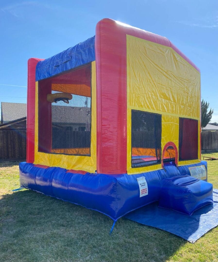 A large inflatable bounce house in the yard.