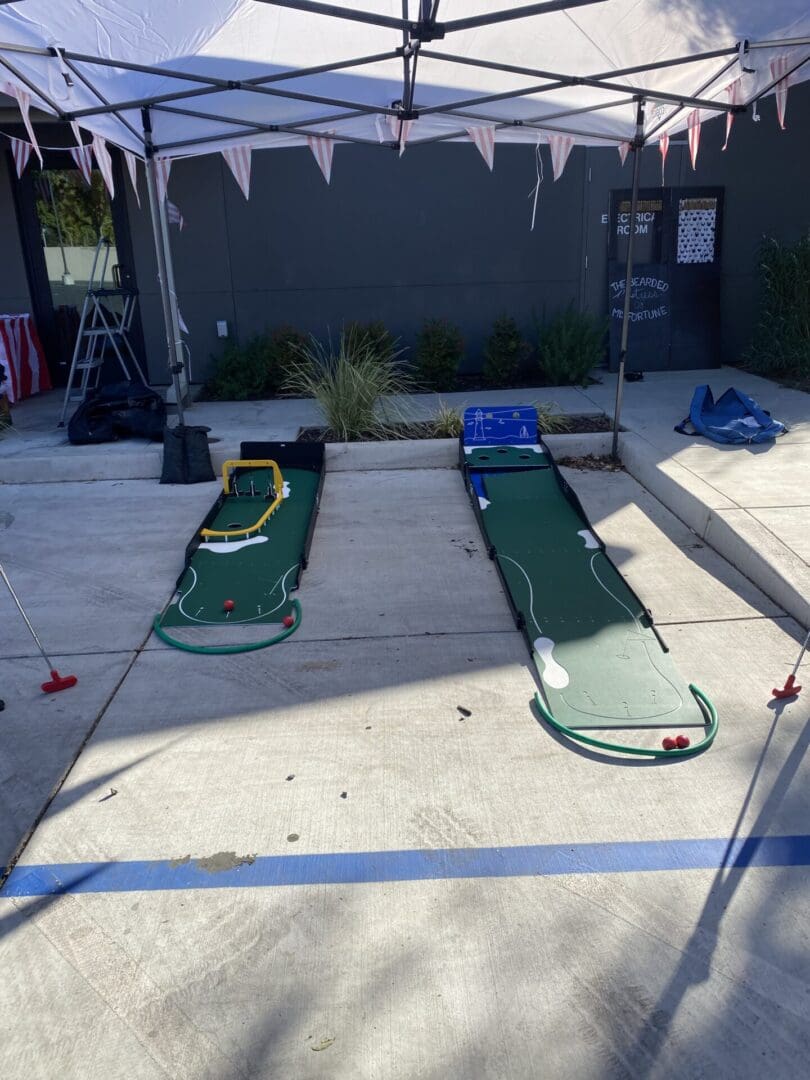 Two green beds are set up on the ground.