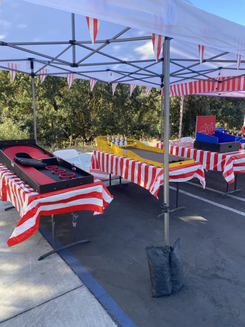 A group of tables with red and white striped table covers.